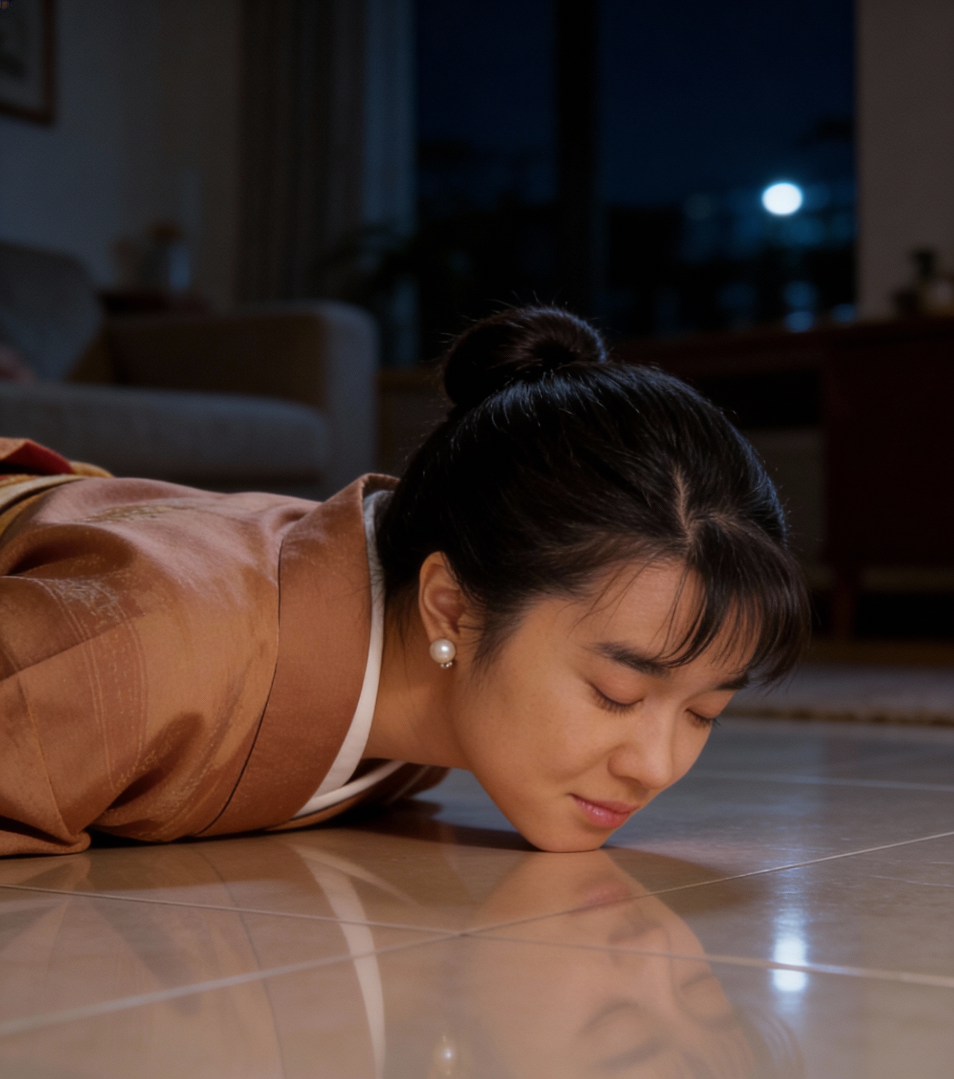 Woman lying on a tiled floor, touching her face to her reflection in the tiles.