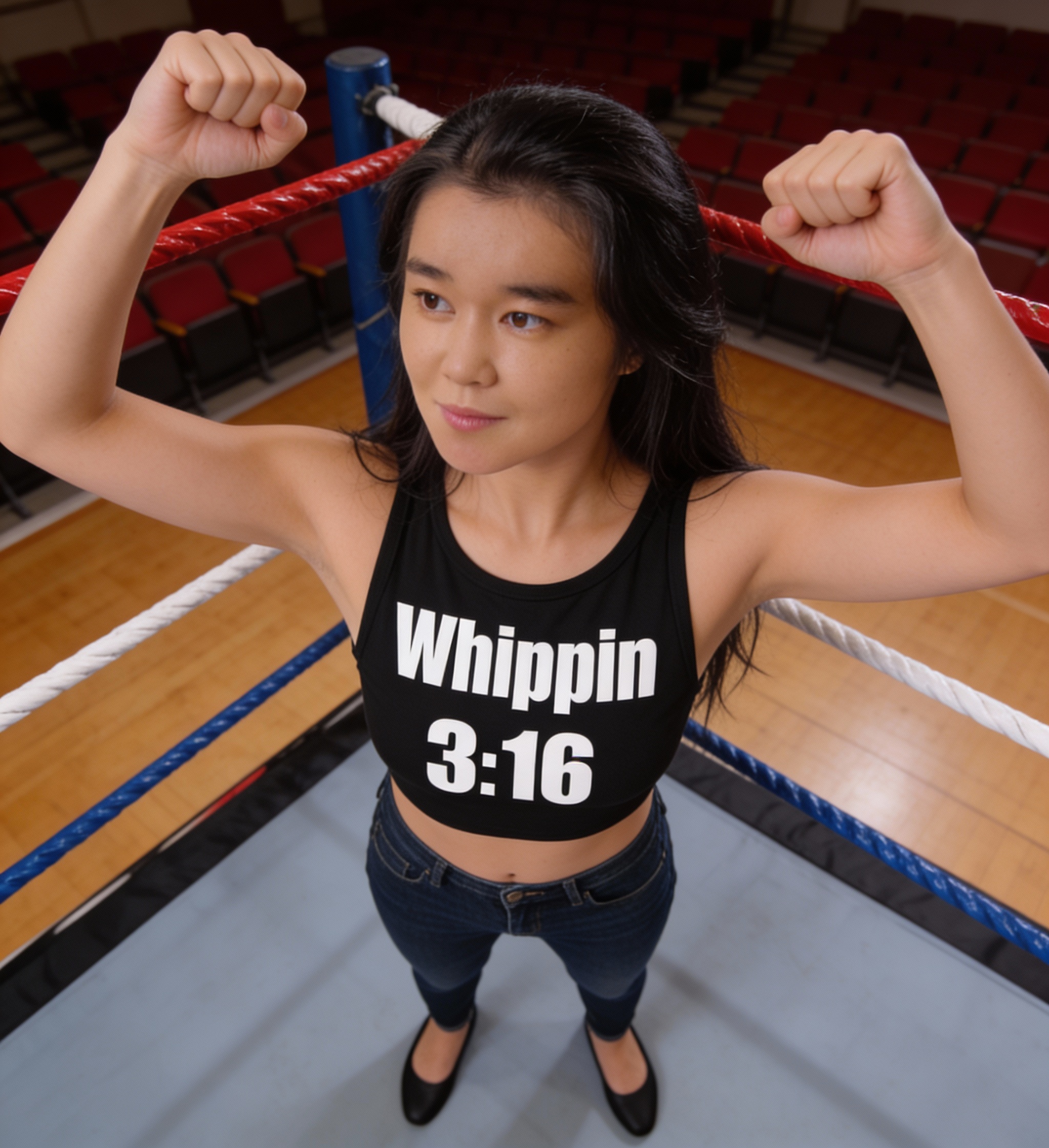 Female boxer in a ring, fists raised, wearing a black crop top that reads "Whippin 3:16".